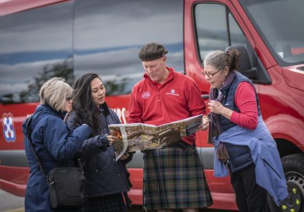 People standing near the bus - Heart of Scotland Tours